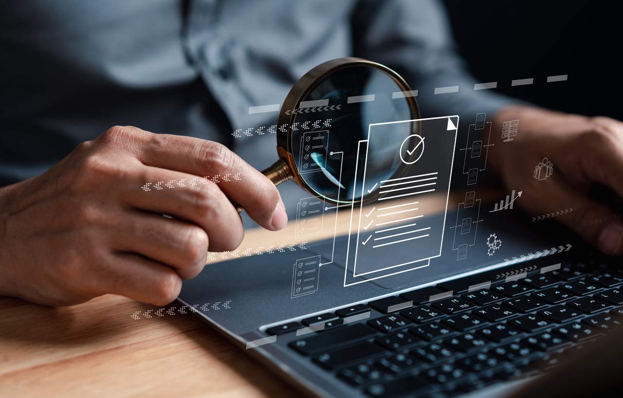 Close up of a business man at a laptop due diligence investigation